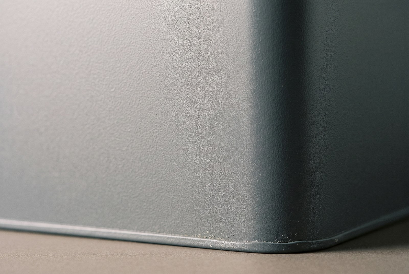 Macro of a powder-coated panel showing its fine sandy texture